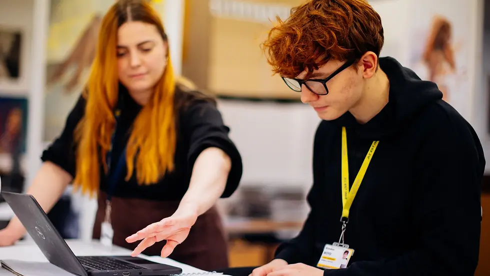 A sixth form student sitting at a laptop reviewing their UCAS Hub with progress tutor