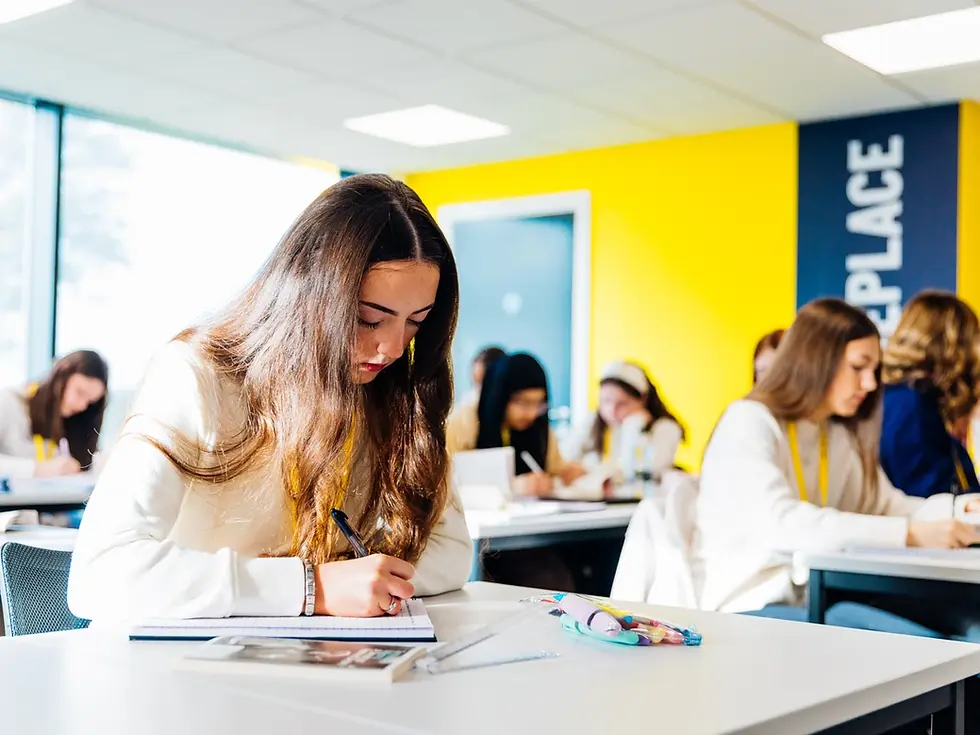 JLC student in a bright A Block classroom, studying and making notes for one of many A-Levels offered at John Leggott college