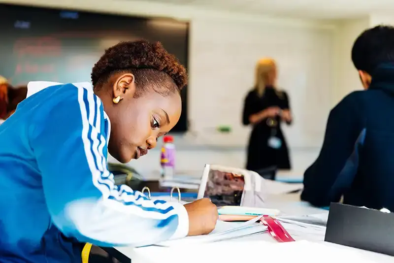 A John Leggott college student in lesson working at a desk