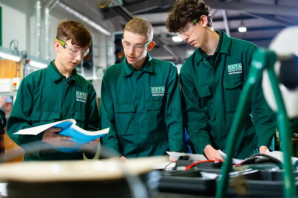 A student in engineering overalls working at a workbench during a practical HETA engineering apprenticeship session in the Humber region.