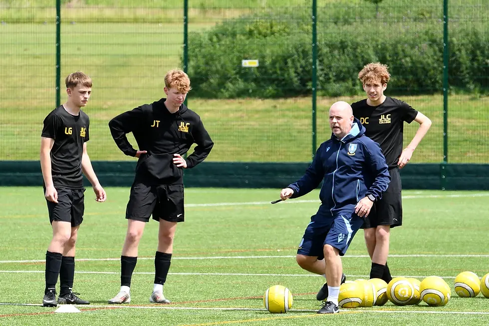 JLC student footballers taking part in a coaching session on the college pitch with Andrew Sharp, Head of Coaching at Sheffield Wednesday Football Club.