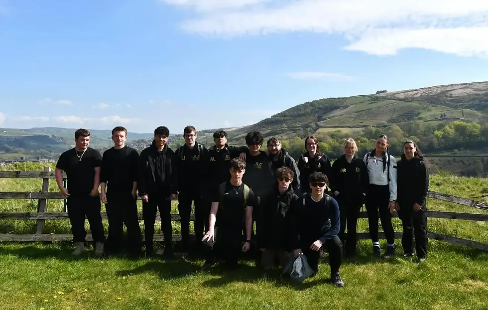 Level 2 UPS students from John Leggott College hiking across moorland at Wessenden Head, supporting one another on a challenging outdoor enrichment activity.