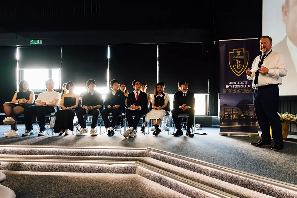 Alumni students at John Leggott college graduation ceremony inside the Core with Principal Leon