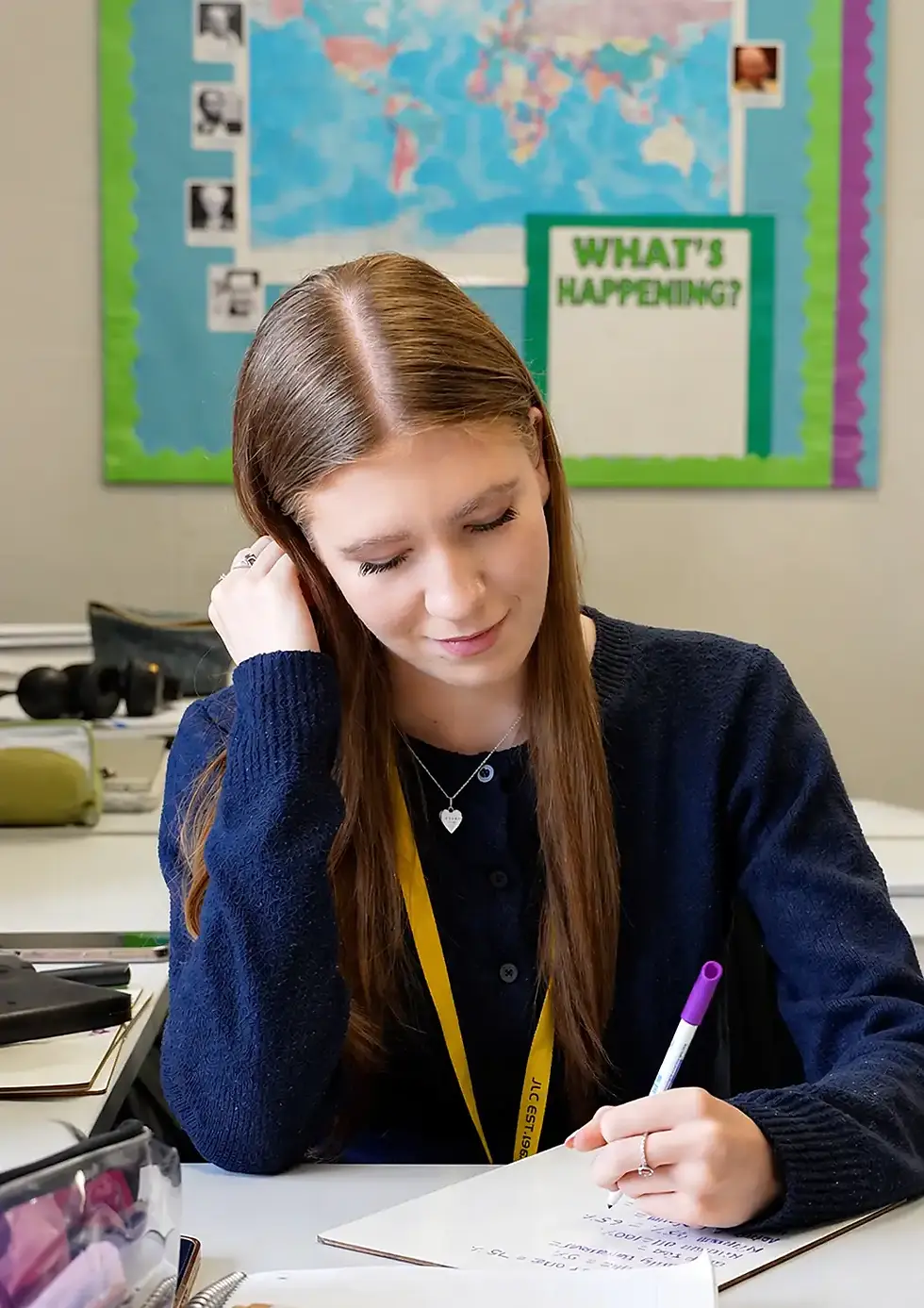 Students sitting in a Social Science classroom completing focused A Level revision with notebooks, textbooks and study materials