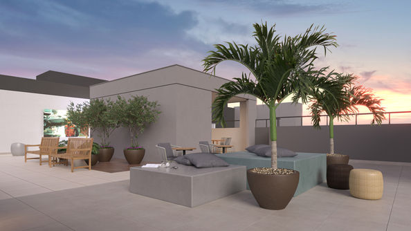 Área de lazer no terraço com assentos modernos e palmeira ao pôr do sol.