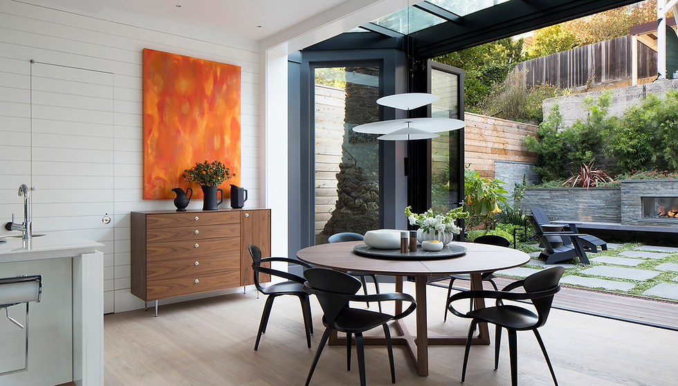 Modern dining room with patio view through open glass doors