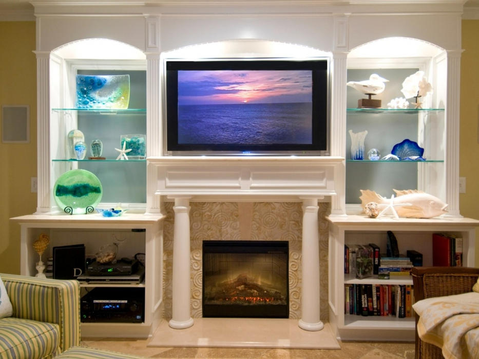 Built-in white entertainment center with fireplace and TV