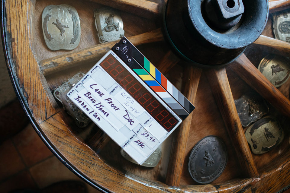Clapperboard with the text "Lone Ranger Doc" on a wooden wagon wheel background.