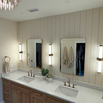Modern bathroom vanity with double sinks and gold accents