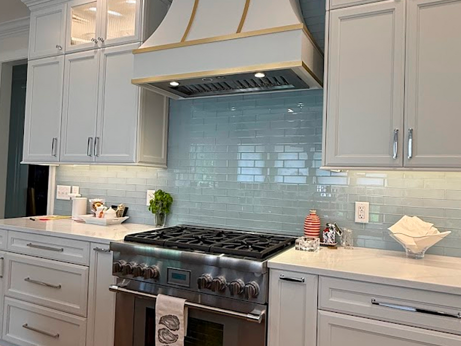 Modern kitchen with white cabinets and blue tile backsplash