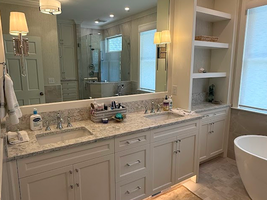 Modern double vanity bathroom with white cabinets and tub