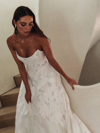 Dance in all the Glori-osa that you found your dream wedding dress! She has it all. A classic silhouette and a modern take on a jacquard organza. So twirl all night long because you and your dress will forever be breathtaking. 