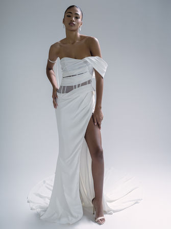 Romy by Gabrielle is pure bridal goddess energy. ✨ This sleek crepe stunner is all about modern sophistication, featuring an asymmetrical neckline with a single off-the-shoulder sleeve for that effortlessly chic vibe. Draping on the bodice and skirt creates a sculpted, flattering fit, while cutouts with exposed boning bring just the right amount of edge. And let’s not forget the thigh-high slit—hello, red carpet moment! Finished with a corset back and a long, dramatic train, Romy guarantees all eyes on you.