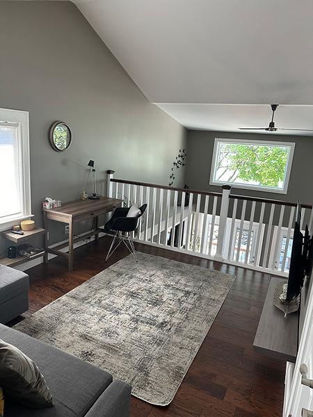 Second floor office at The Lakeside House with a desk, window view, and pull-out sofa bed for additional sleeping space