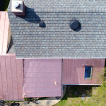 Roof featuring copper accents that highlight and enhance the look of surrounding shingles, adding warmth and visual contrast.