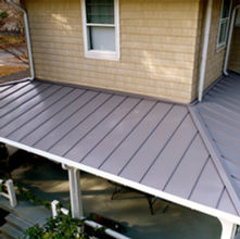 Swarthmore, PA home with a metal porch roof, showcasing modern design and durable construction.
