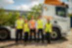 group of people stood in front of lorry
