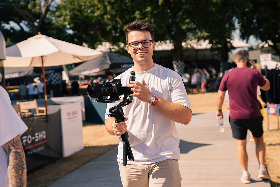 man in white shirt holding camera on gimbal