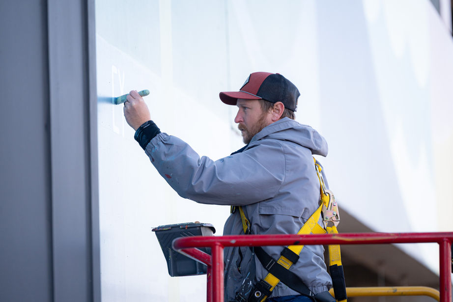Large geometric mural with net-zero living shapes and symbols