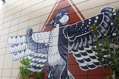 a geometric black, white, and red Cockaded Woodpecker by muralist Christian Stanley 