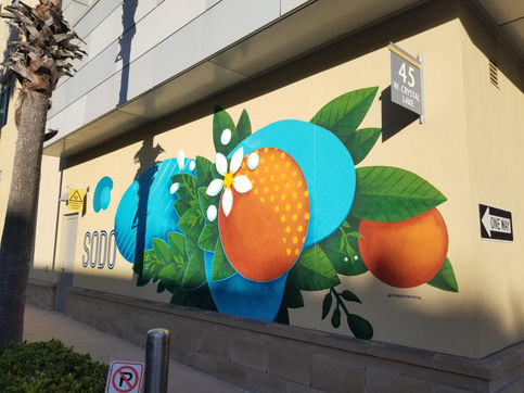 Oranges and orange blossoms mural in the SODO Plaza by muralist Christian Stanley