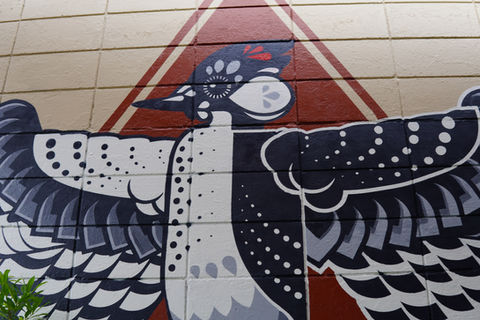 a geometric black, white, and red Cockaded Woodpecker by muralist Christian Stanley 