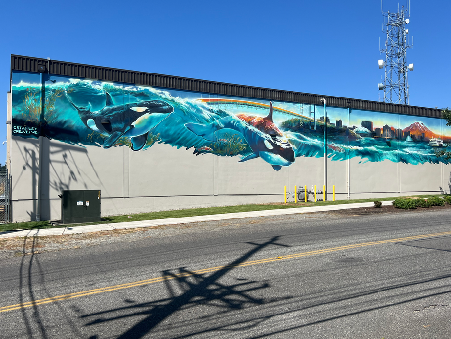 The "Mountains to Sound" mural located on the Pierce County Election Center in Tacoma, WA. This mural features all things Tacoma, including orca whales, sea planes, and the city skyline. 
