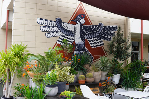 a geometric black, white, and red Cockaded Woodpecker by muralist Christian Stanley 