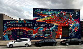 This mural titled "Chance" features a large orange and blue alligator and is located in Chicago, IL. It was painted in 2022 as a part of the Titan Walls Mural Festival by artist Christian Stanley 