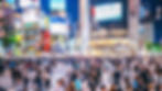 Shibuya crossing full of shoppers on a weekday evening.