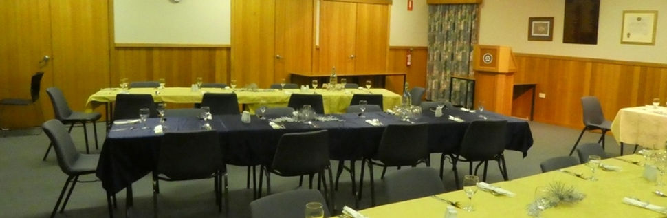 Room with tables and chairs set up for a meal