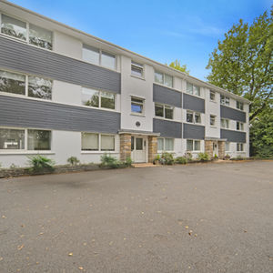 Exterior view of Heol Don Court apartment building with parking area in Whitchurch, Cardiff.