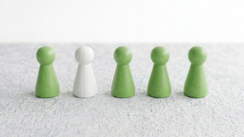a row of pawns, all green with one white