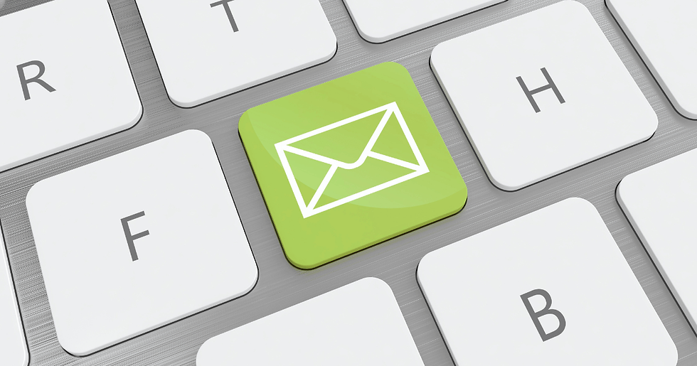 Close-up of a keyboard with a bright green key featuring a white envelope icon, surrounded by standard gray keys with letters.