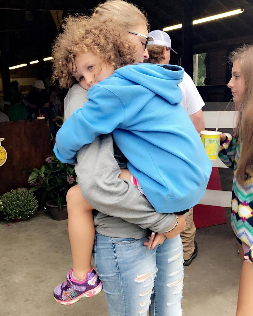 Teen Holding Little Girl