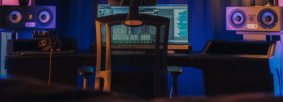 a room with a desk and speakers_edited.png