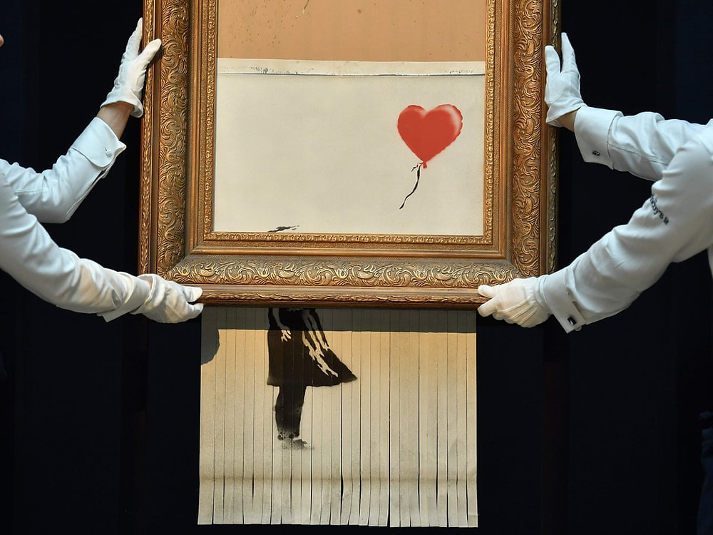 Tableau artistique la « Fille au Ballon » de Banksy qui s’auto-détruit sous les yeux de l’acquéreur