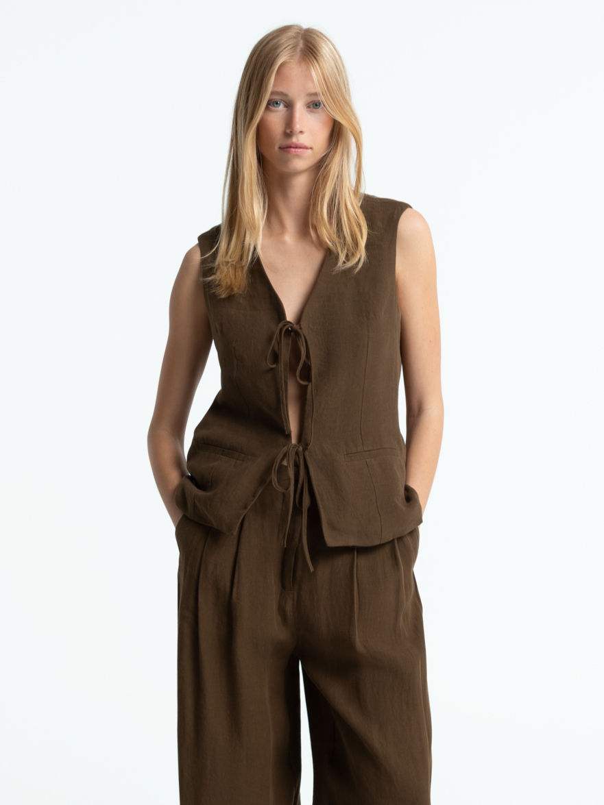 Ecommerce model photo of a sustainable Kings of Indigo set, with blonde haired female model in brown linnen set