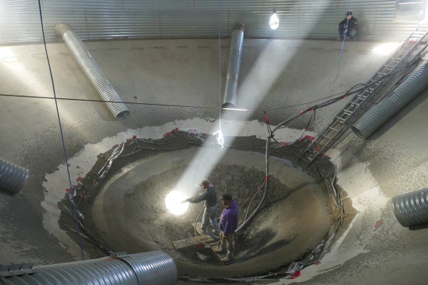 Repairing the floor of a grain silo.