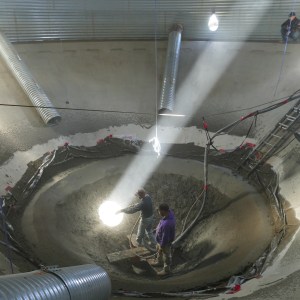Repairing the floor of a grain silo.