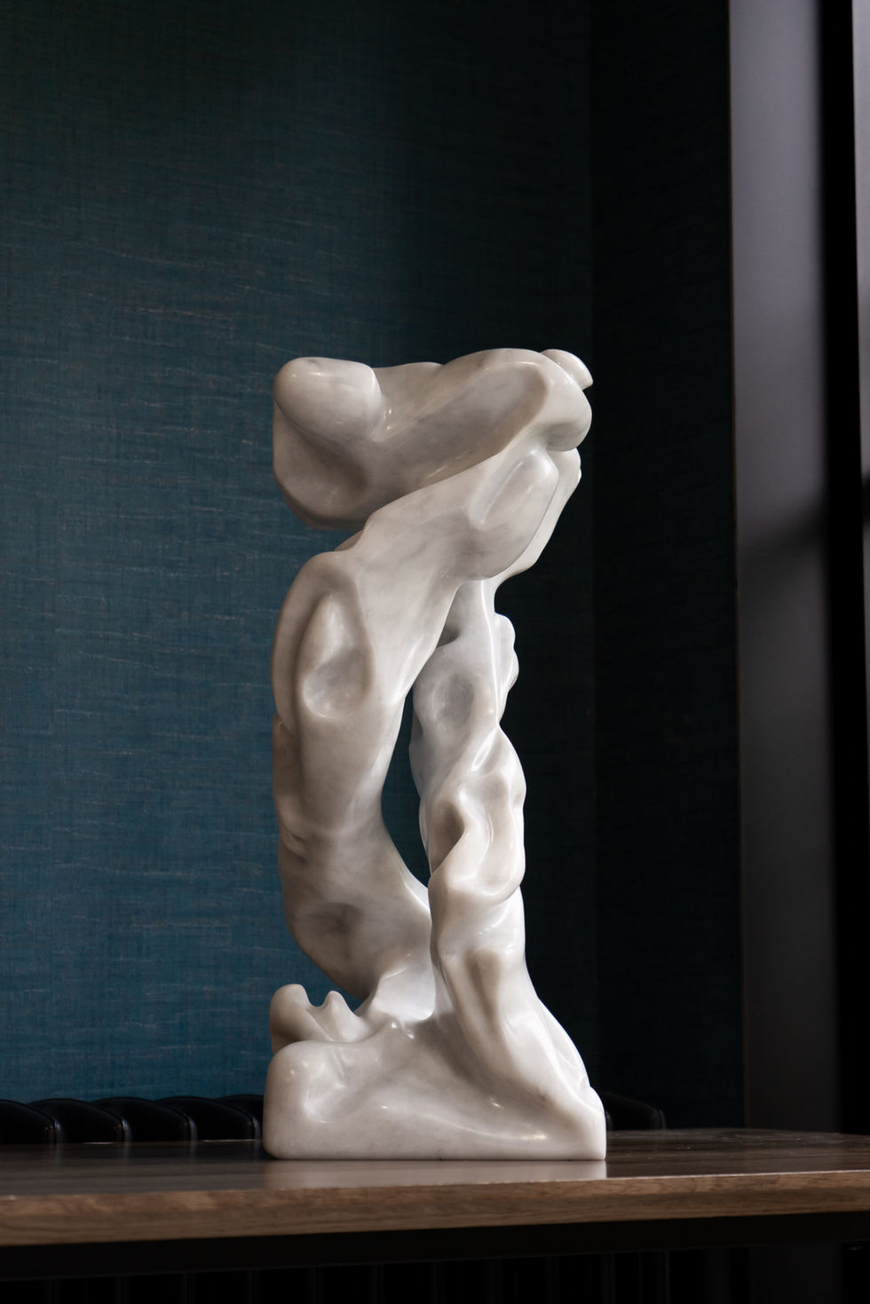 Infinity – is a study in continuous movement and quiet strength. Carved from luminous marble, the sculpture rises in a seamle