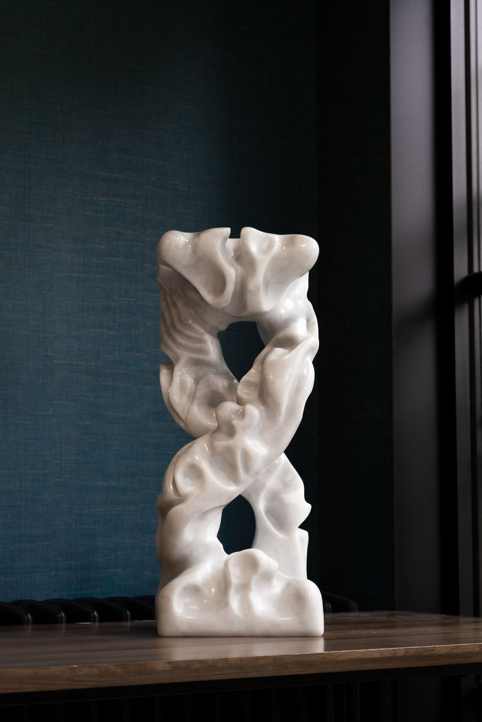 Infinity – is a study in continuous movement and quiet strength. Carved from luminous marble, the sculpture rises in a seamle
