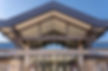 Front entrance of Asheville Christian Academy featuring stone columns, metal beams, and modern architectural design – Buchanan Commercial Construction, Asheville