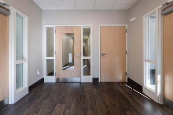 Interior hallway entrance with wooden doors and glass panels at 141 Ashland Avenue – Buchanan Commercial Construction, Asheville.