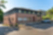 Two-story brick commercial office building with arched entrance and modern windows – Buchanan Commercial Construction, Asheville