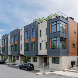 Modern multi-story townhome exterior with clean lines, large windows, and neutral tones – Buchanan Commercial Construction, Asheville