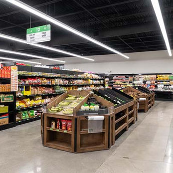 Produce and grocery aisles at Asheville Asian Market featuring new shelving, lighting, and polished concrete floors – Buchanan Commercial Construction, Asheville.