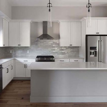Modern kitchen with white cabinetry, stainless steel appliances, and a center island – Buchanan Commercial Construction, Asheville.