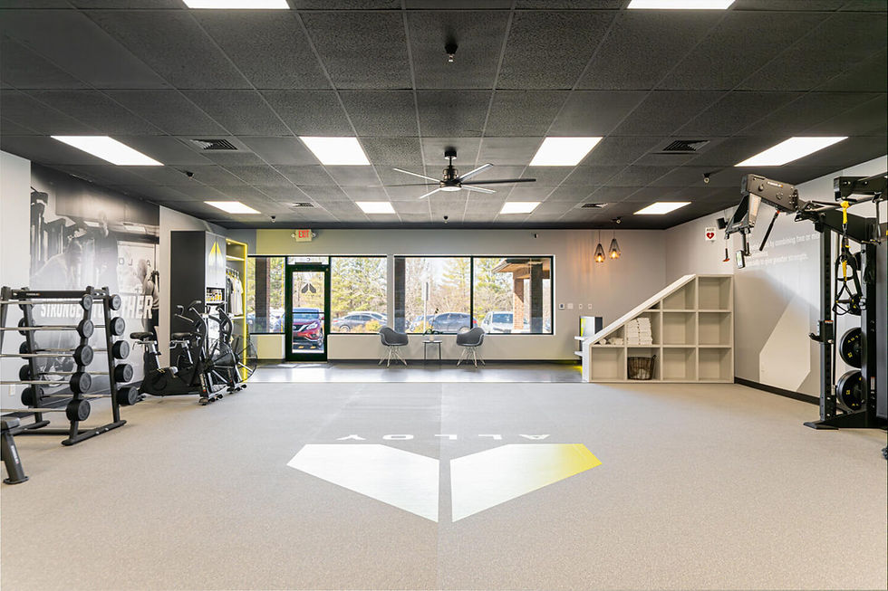 Modern fitness studio interior featuring gym equipment, open training space, and large front windows – Buchanan Commercial Construction, Asheville