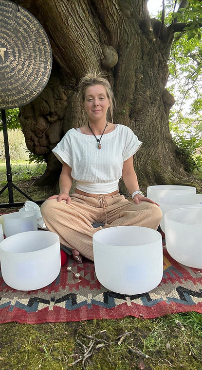 The Coaching Retreat Kate conducting a sound bath session with her bowl outside